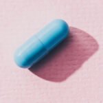 blue medicine on pink surface